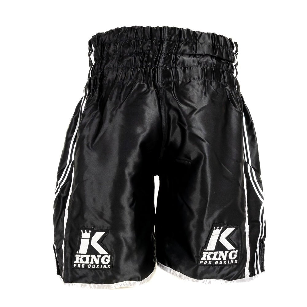 Detail of the elastic waistband with internal drawcord and embroidered KING logo of the black XK shorts.
