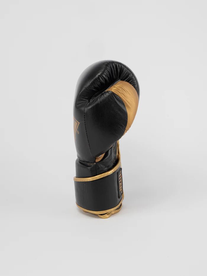 Vista lateral da luva Metal Boxing Titan em ouro preto, detalhe de apoio para o polegar