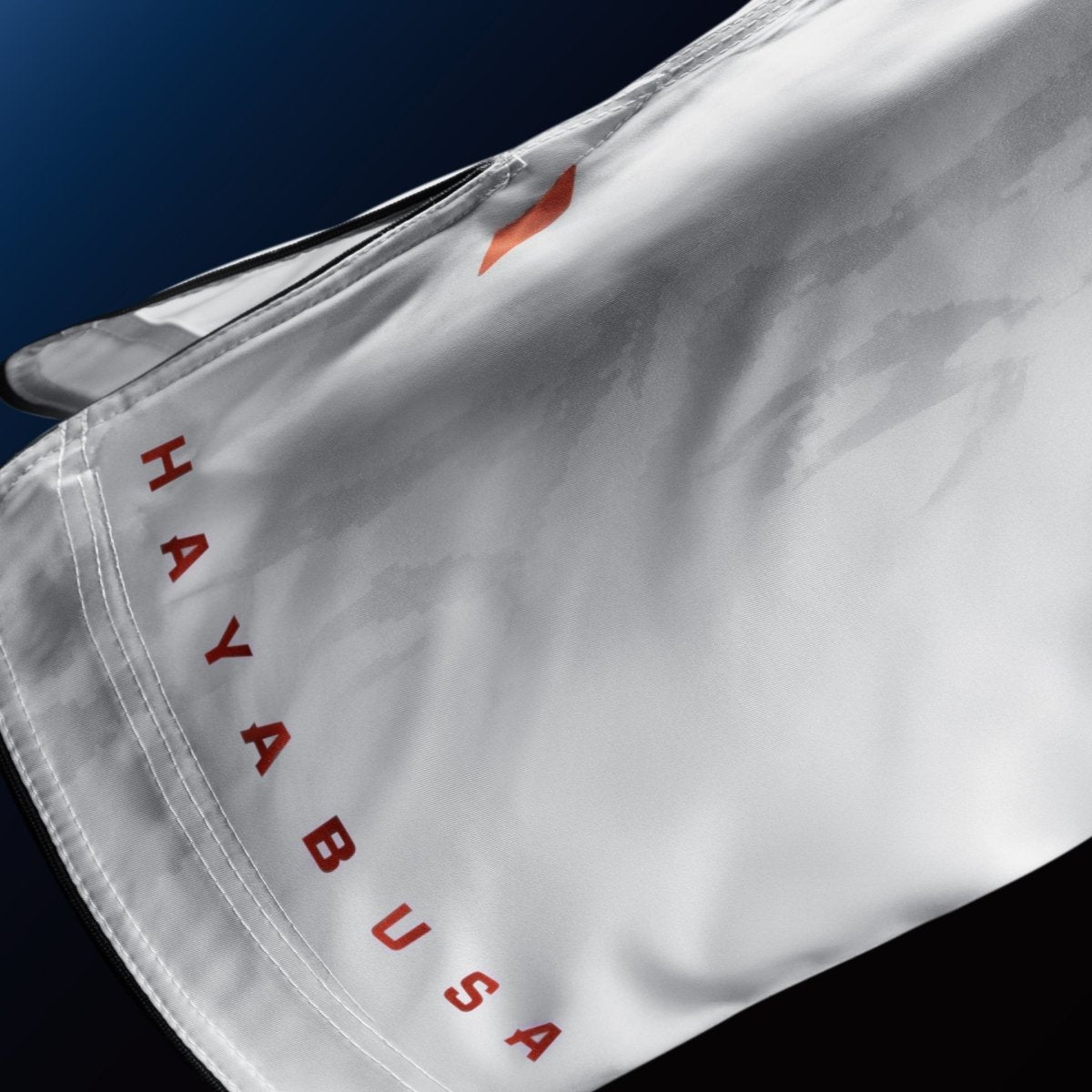Detail of the Hayabusa brand writing on the leg of the white shorts for BJJ and MMA