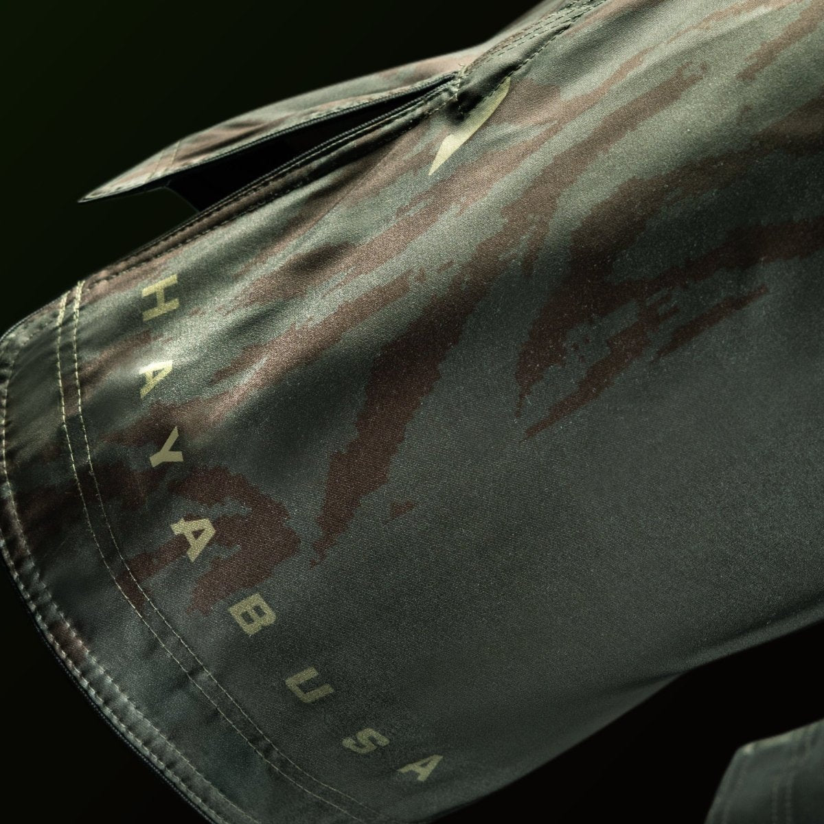 Detail of the Hayabusa logo and writing printed on the leg of the full-length green shorts