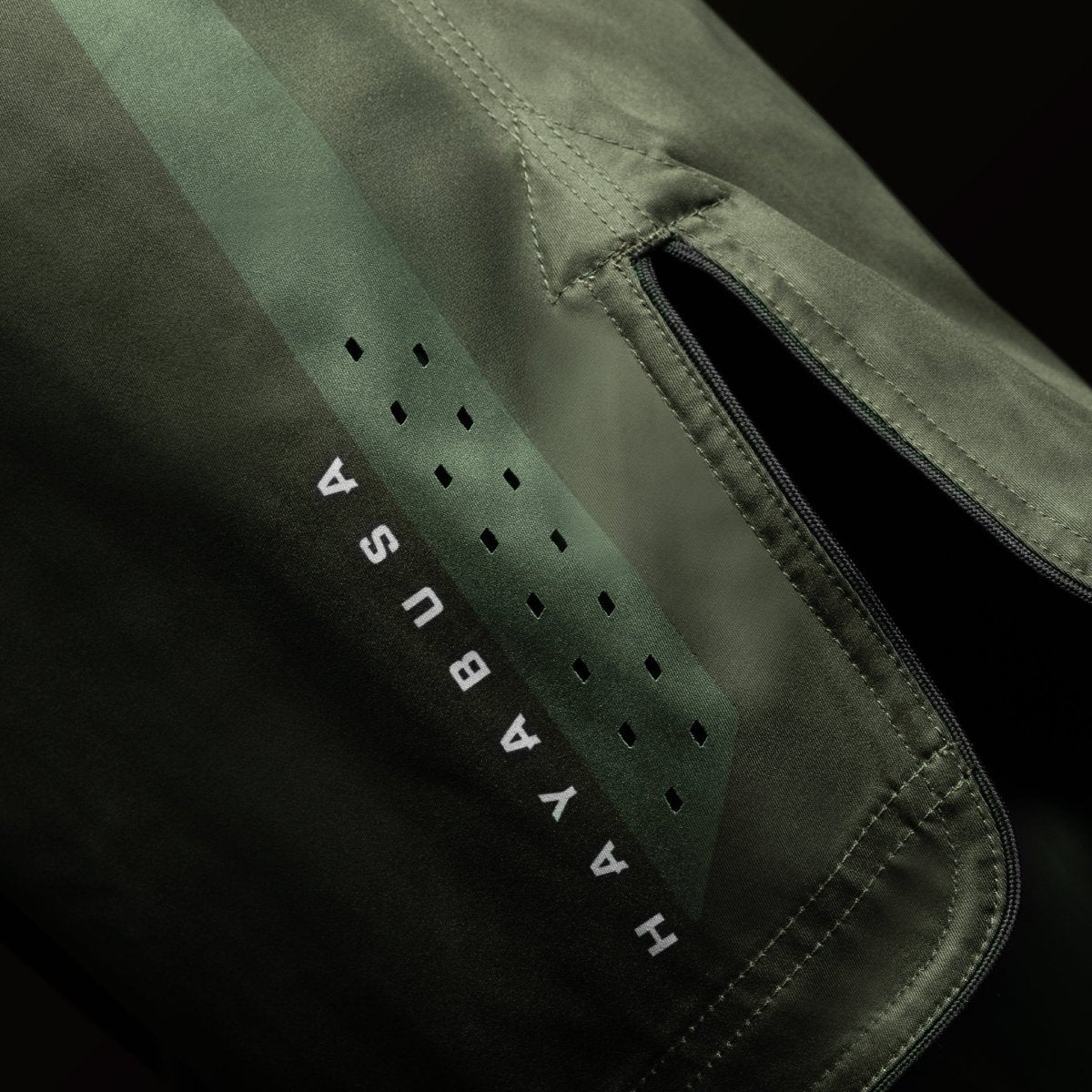 Side view of the green Hayabusa Core Mid-Thigh MMA Shorts, highlights side vents for mobility