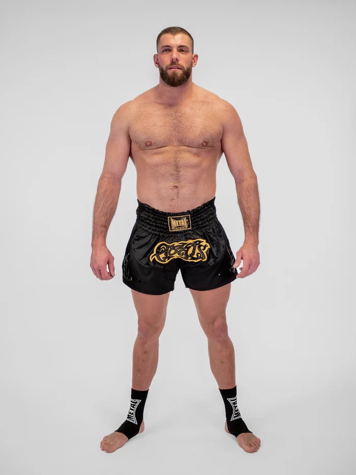 Szczegóły technicznego materiału i wykończenia czarnych męskich spodenek Muay Thai firmy Metal Boxing