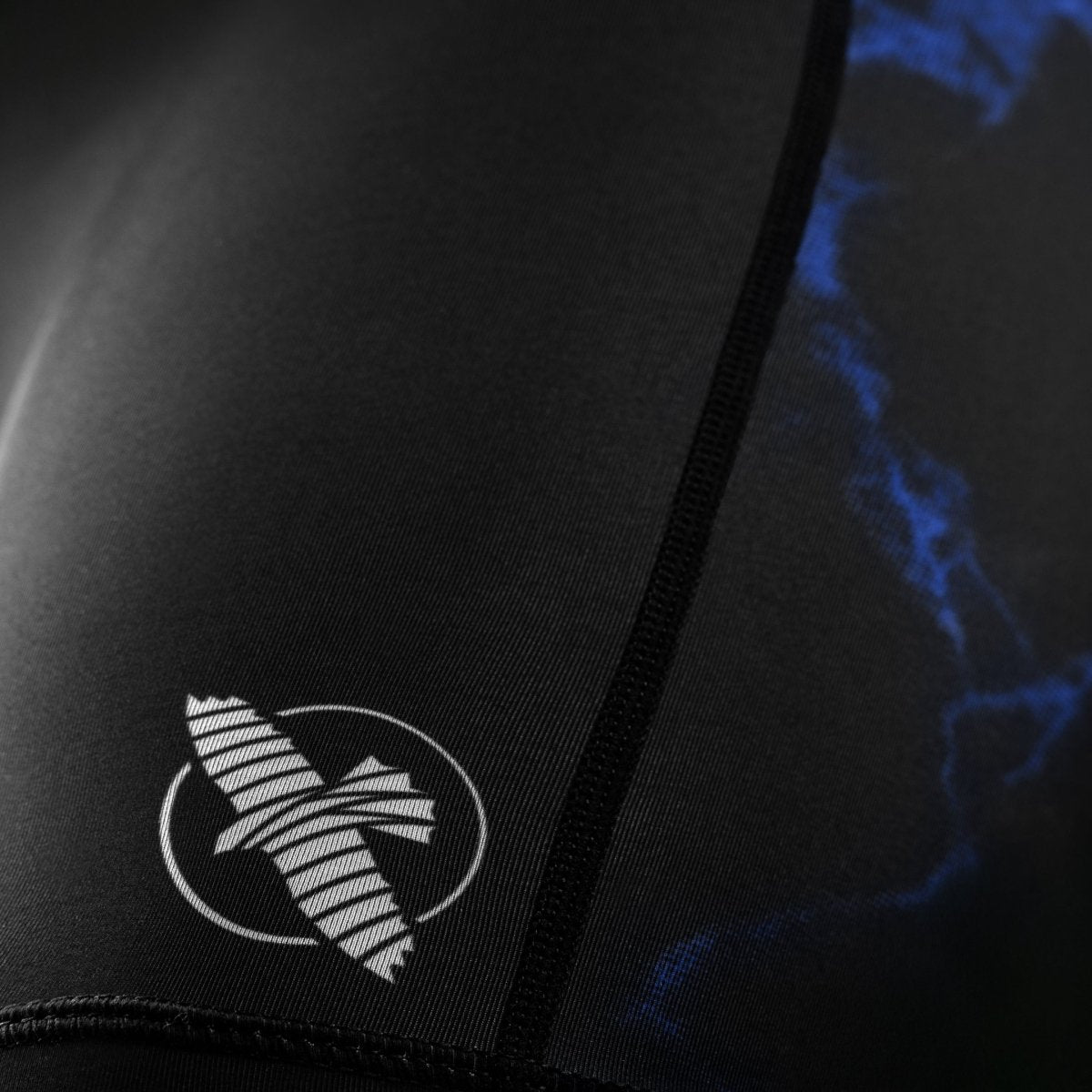 Detail of the UFC graphics printed on the leg of the black and blue Vale Tudo women's shorts
