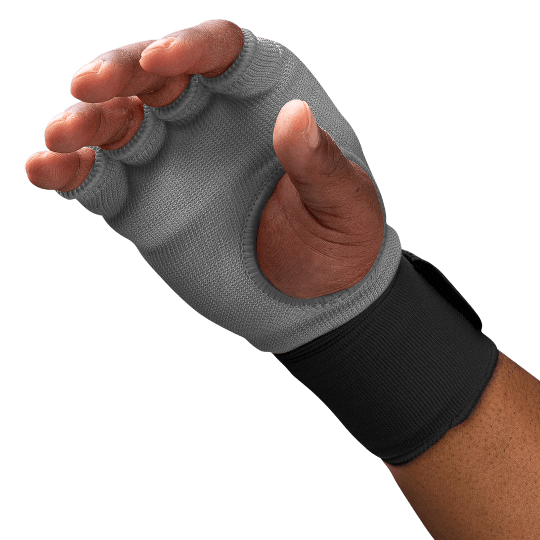 Close-up detail of the gel-padded knuckles of the worn gray Hayabusa glove