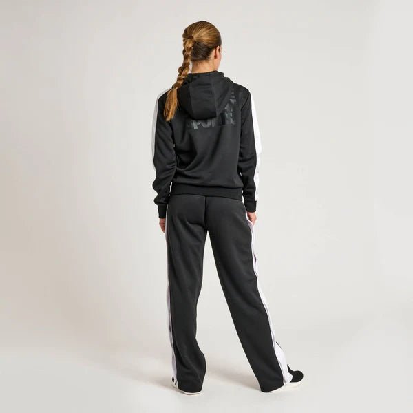 Vista trasera del chándal negro Leone Stripe para mujer que muestra la capucha y el ajuste.