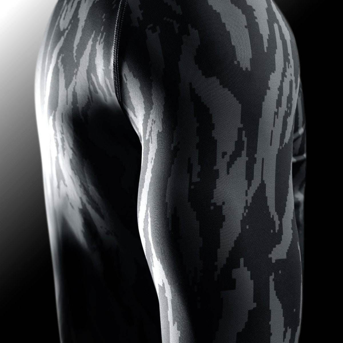 Detail of the sleeve of the black Hayabusa Apex rash guard, showing the texture of the high-tensile fabric